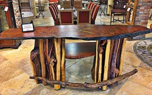 A wooden table with chairs in the background.