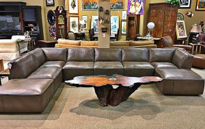 A large sectional couch with a coffee table in the middle.