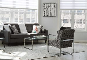 A living room with a couch, chair and coffee table.