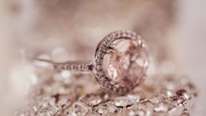 A diamond ring sitting on top of some diamonds.