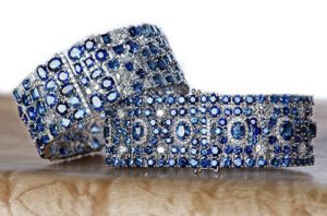 A close up of two bracelets with blue stones